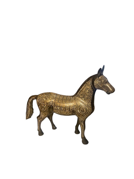 An ornate brass horse figurine with intricate gold and bronze engravings, set against a plain white background.