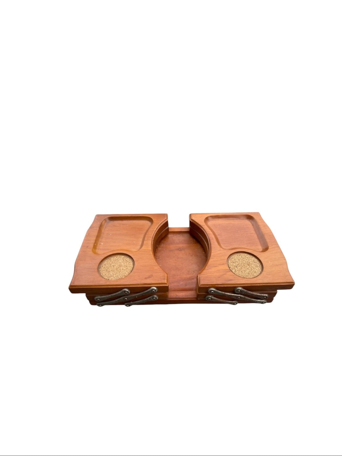 A wooden game board or tray with two raised playing areas, circular cork-like inserts, and small dark metal pieces along the bottom, shown on a plain white background.