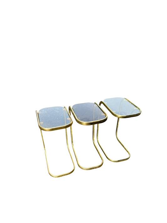 Three small nesting side tables with square mirrored tops and curved gold metal legs, shown on a plain white background.